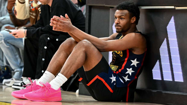 Bronny James sits next to the scoring table, waiting to check-in to the McDonald’s All American game.